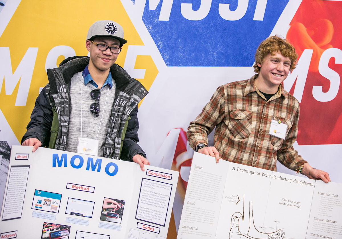 High school students showing their posters at Maine State Science Fair