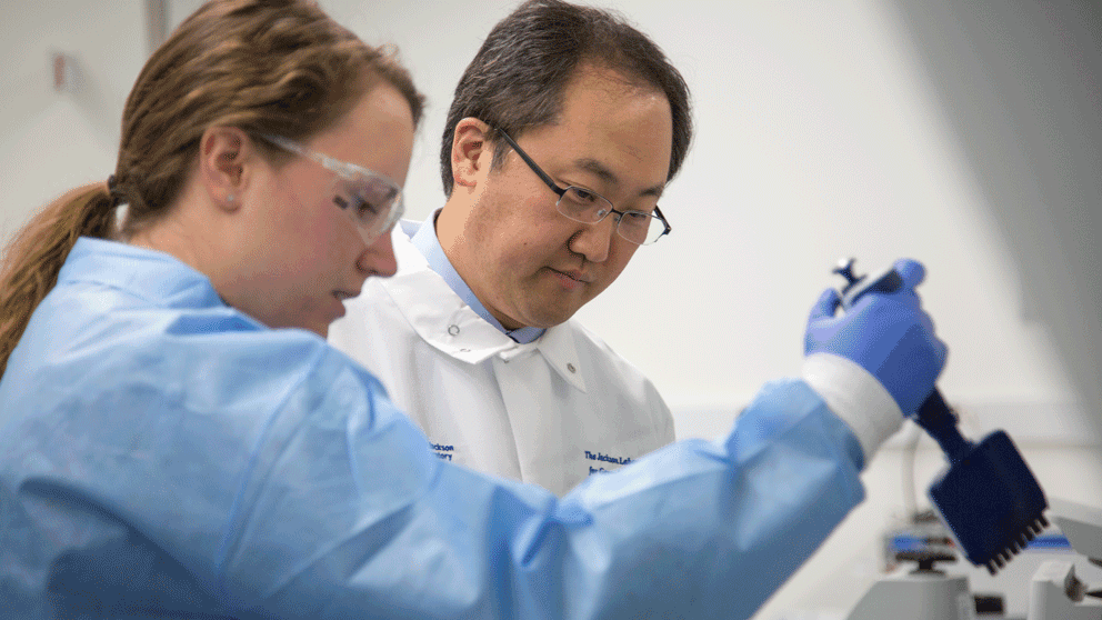 Dr. Charles Lee in lab with an associate