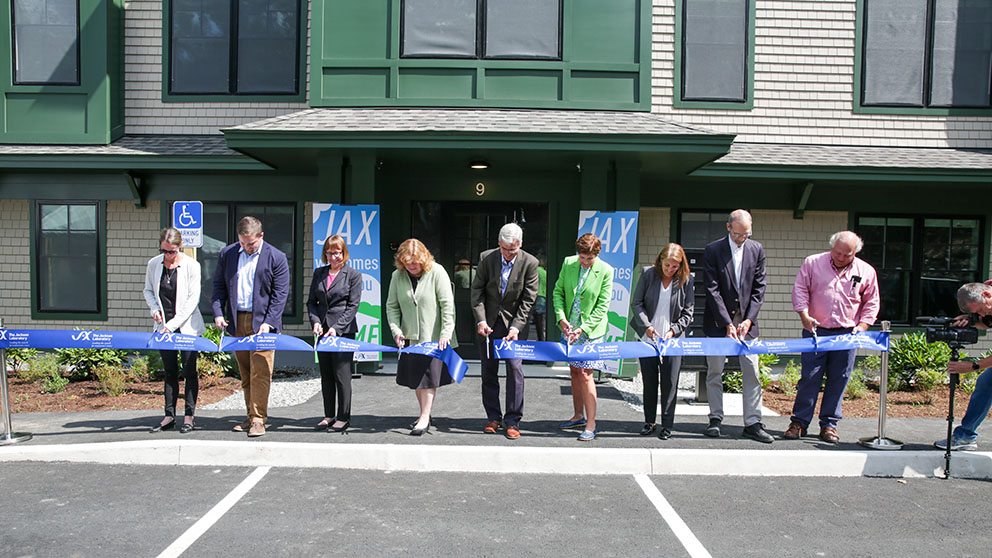 Employees from the Jackson Laboratory and community leaders cut the ribbon on employee housing.