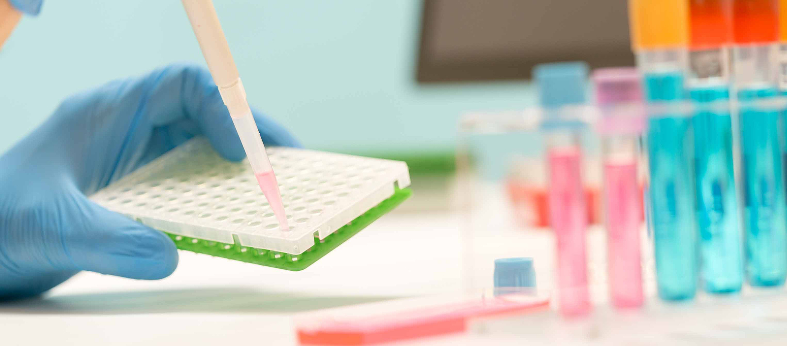stock photograph of a lab tech handling pipettes in a genetic lab