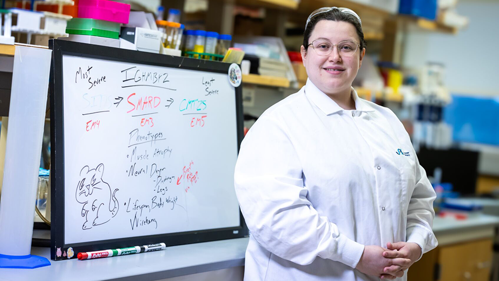 The Jackson Laboratory's Sarah Holbrook in her lab at a whiteboard.