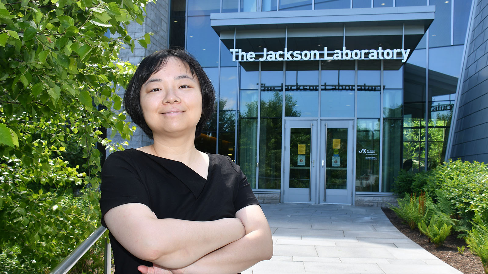 JAX's Sheng Li standing outside the JAX Genomic Medicine building in Farmington, CT.